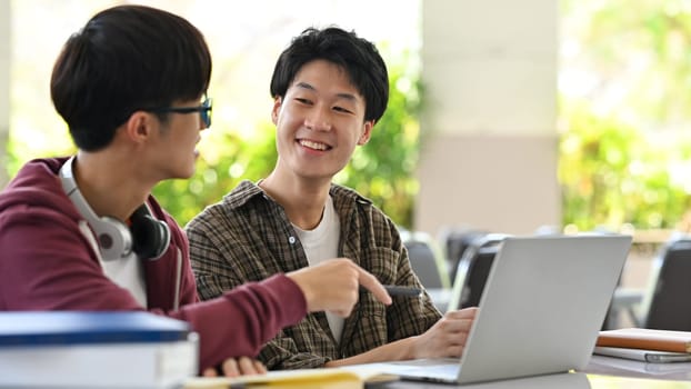 Group of students are working on academic project or preparing for exam together. Education, Learning and technology concept.