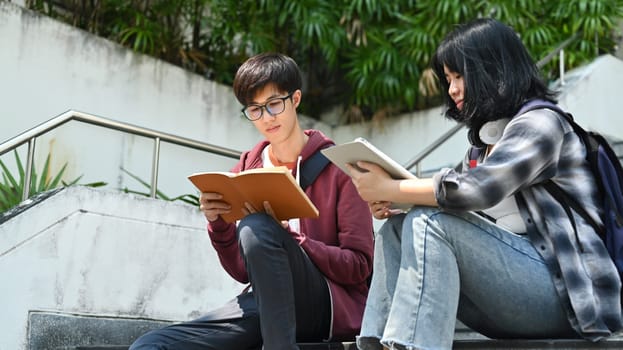 Group of students are working on academic project or preparing for exam together. Education, Learning and technology concept.