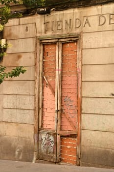 Vertical shot of a bricked-up door of an old house in Madrid, Spain