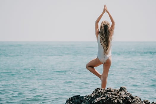 Silhouette mother and daughter doing yoga at beach. Woman on yoga mat in beach meditation, mental health training or mind wellness by ocean, sea