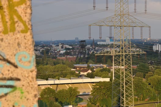 High voltage pylons and graffiti on concrete in Ruhr area, NRW, Germany