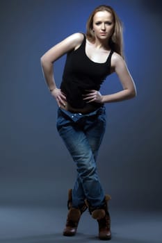 Slender young model shows trendy casual clothes in studio