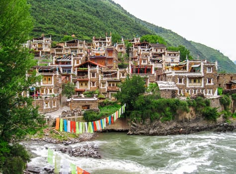 old Tibetan village crossed by a mountain river, travel reportage