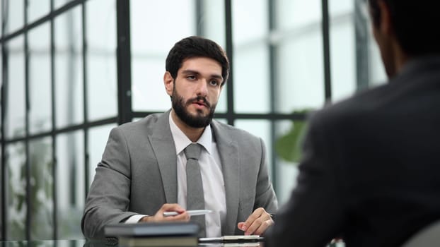 Two business people in the office at the table