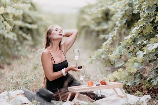 Picnic and wine tasting at sunset in the hills of Italy, Tuscany. Vineyards and open nature in the summer. Romantic dinner, fruit and wine.