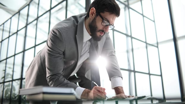 Young businessman signing a contract in the office