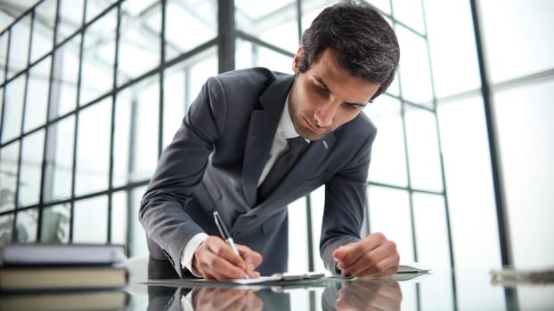 Take your time to skim the fine print. Close-up shot of a person signing documents.