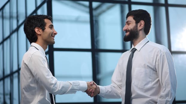 handshake business partners after discussion of the contract