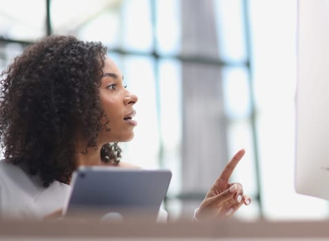 Confident businesswoman with digital tablet in office