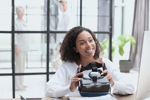woman testing VR glasses or goggles sitting in the office room