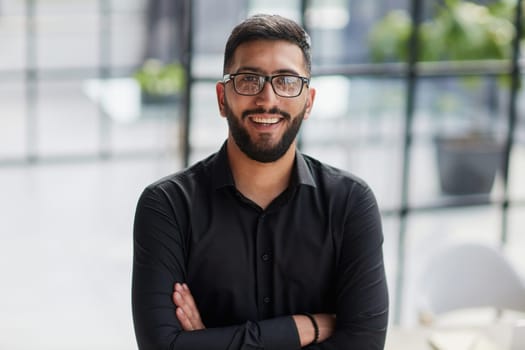 Businessman portrait. Happy confident young businessman standing , smiling, looking at camera.