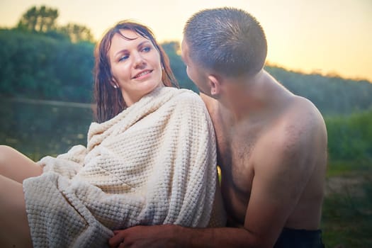 Happy Couple Outdoor relaxin, having fun and hugs on nature in park. Family or lovers have date and rest outdoors. Concept of love and friendship