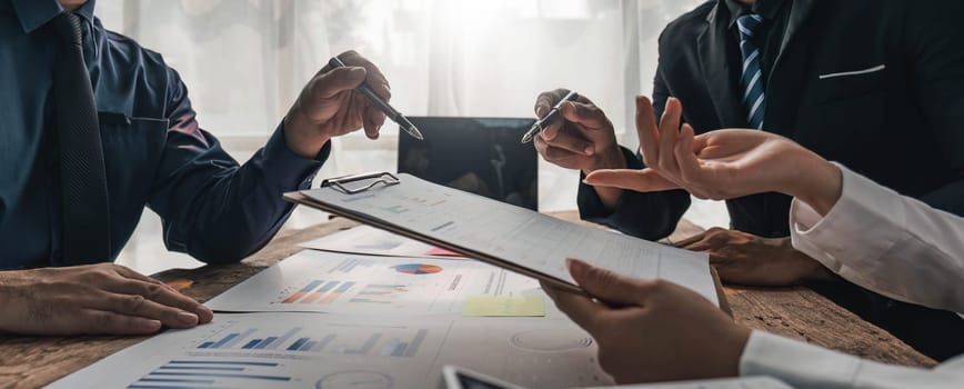 Business People Meeting using laptop computer,calculator,notebook,stock market chart paper for analysis Plans to improve quality next month. Conference Discussion Corporate Concept