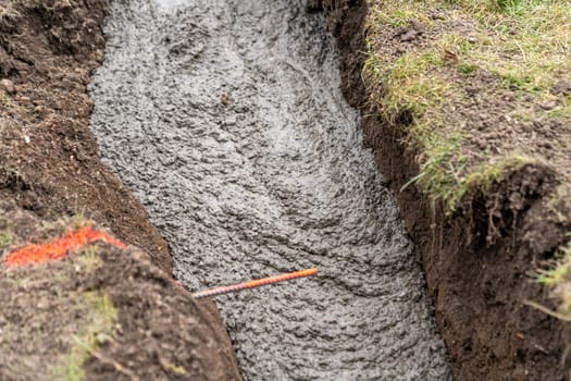 cementing the foundation in the ground when building a house.