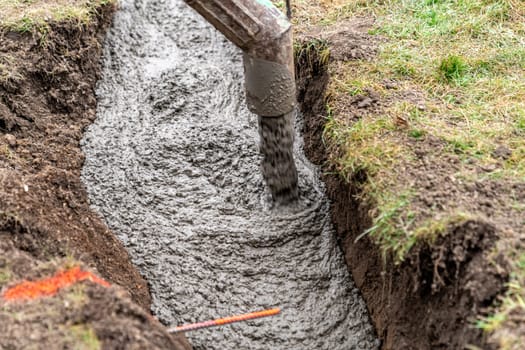 cementing the foundation in the ground when building a house.