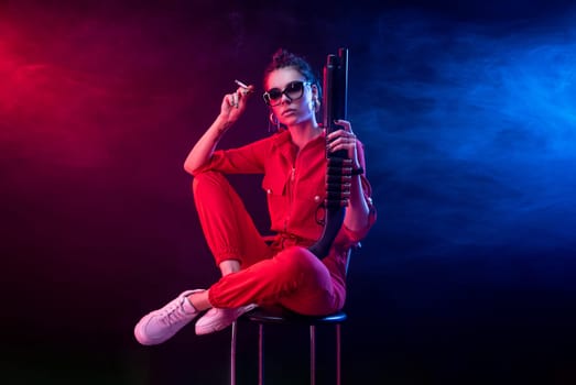 sexy bully girl smokes a cigarette with a shotgun on a dark background in neon light and a haze of copy paste