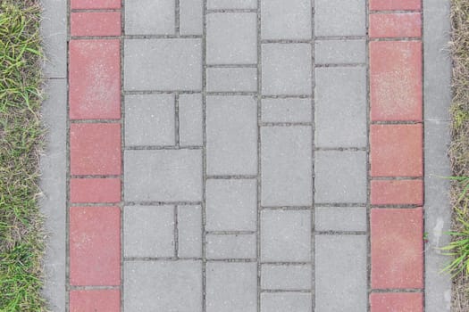 Gray sidewalk tile street stone city road abstract urban pattern color red or pink design texture paving background.