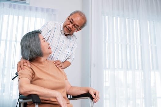 A contented senior couple and their in-home nurse. Elderly female in wheelchair with her young caregiver.