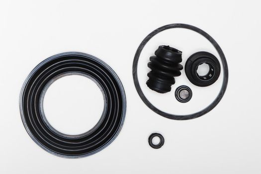 Rubber rings - gasket, oil seal, coupling for repairing a car brake caliper. Set of spare parts for car brake repair. Details on white background, copy space available. UHD 4K.