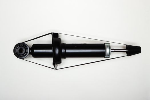 One new shock absorber for the car on a flat surface. A set of spare parts for the repair of the chassis of the vehicle. Details on white background, copy space available. UHD 4K.