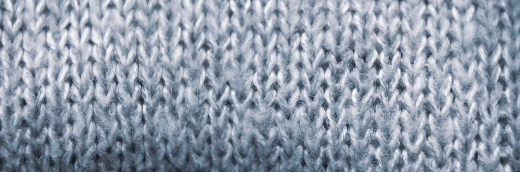 Knitted fabric soft grey natural texture close up.
