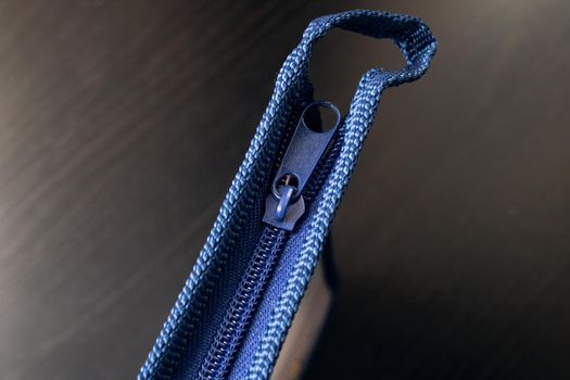 Zippered case isolated on a wooden table close up
