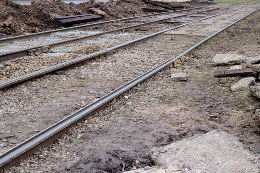 Sand on repair work on tram rails close up