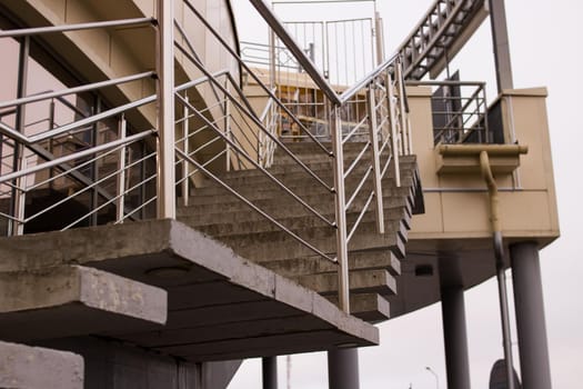 Staircase with metal railing on the sky background