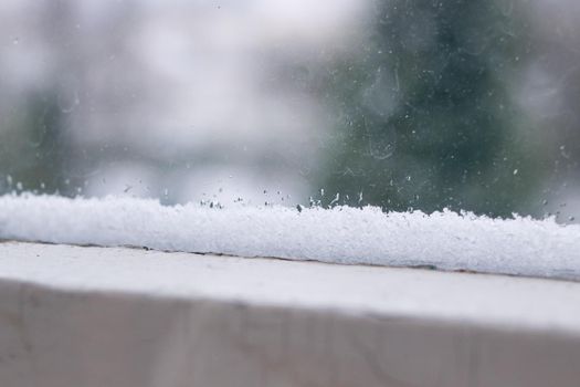 Snowflakes on the window frame close up, macro photo