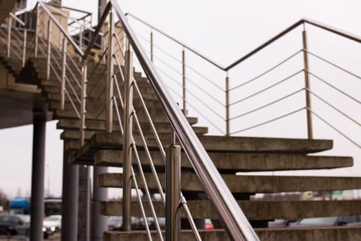 Staircase with metal railing on the sky background