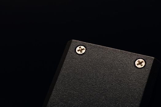 Locked nuts on a black plastic device close up