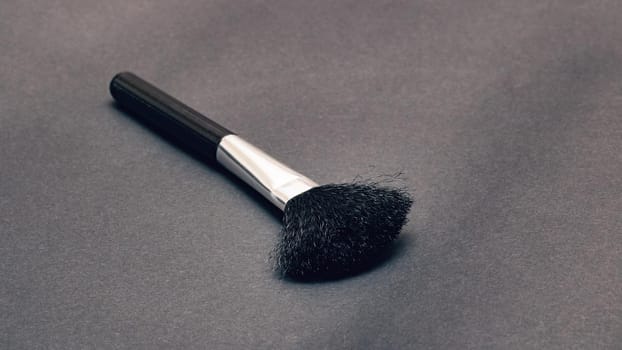 Makeup brush on a gray background close up