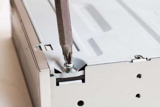 Disassembled computer disk drive on a white background