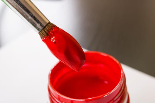 Brush for red paint and can close up