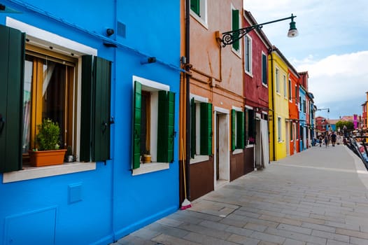 Venice, Italy - 06/09/2009 - Tourists visiting Burano. The island of the Venetian lagoon famous for its brightly colored houses