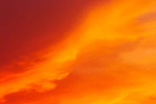 Red-orange sunset bright clouds sky color nature background.