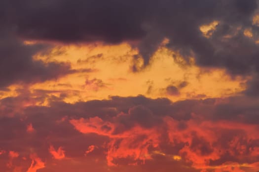 Bright red-orange sunset sky clouds summer background nature evening.