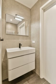 a bathroom with a mirror on the wall and a white sink in the corner next to it is a door