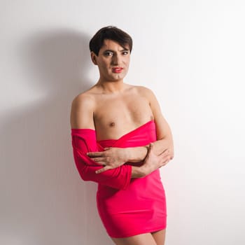 Homosexual in a pink female dress. A man in make-up