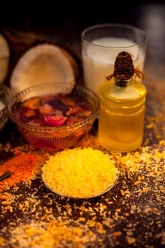 Complete face mask of coconut, consisting of coconut milk, rose water, yogurt, buttermilk, oatmeal, almonds, lime juice, turmeric, rice flour, honey, olive oil, and sandalwood powder. Vertical shot.