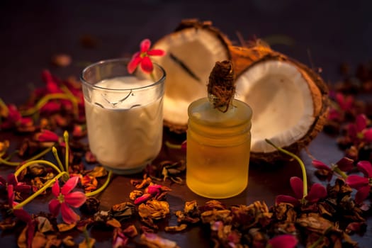 Coconut face mask on the brown colored surface consisting of some coconut milk and olive oil when applied penetrates the skin and exfoliates deeply. Face mask for protection against skin damage.