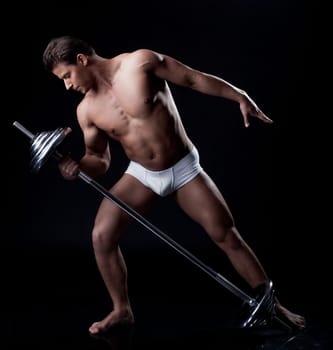 Handsome athlete lifting weights in studio, isolated on black