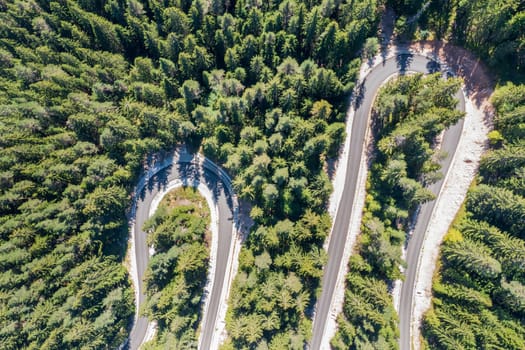 Aerial view from drone of curves of mountain road. Transportation and infrastructure concept