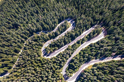 Aerial view from drone of curves of mountain road. Transportation and infrastructure concept