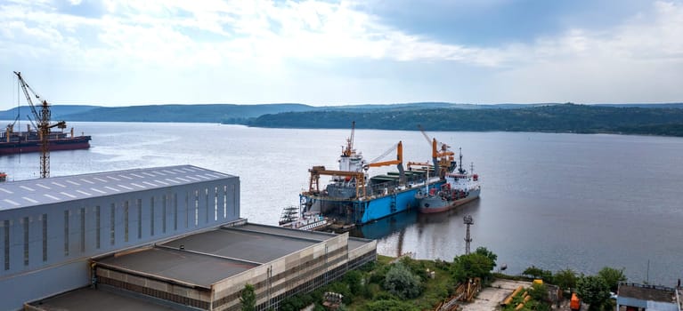 Aerial view from a drone of a ship repair yard with ships. Water transport