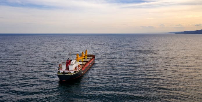 Large ship at sea. Aerial top view of cargo ship vessel import export sailing.