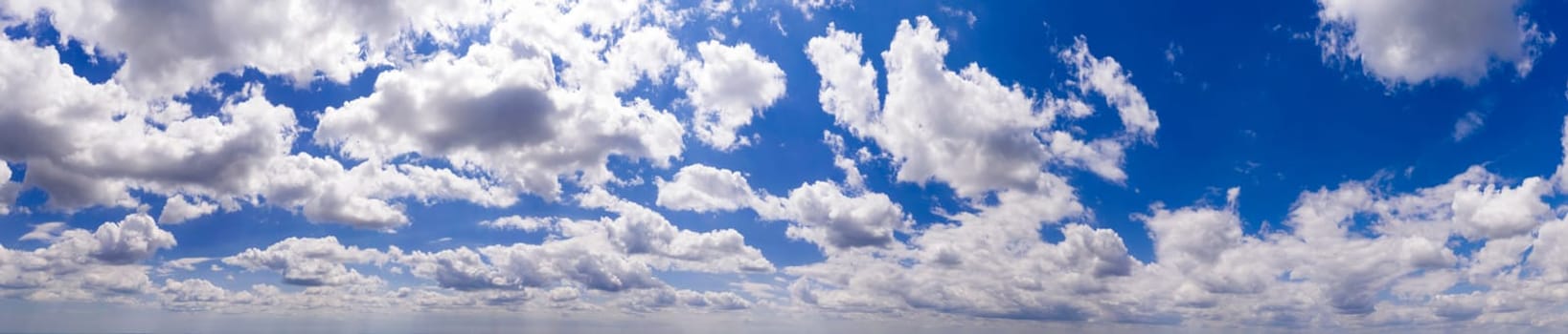 Panoramic view of blue sky with clouds and sunlight