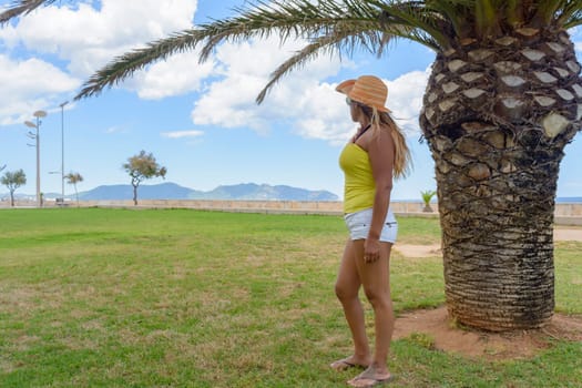 beautiful and happy latin woman with long hair smiling, having a good time, on vacation in mallorca hollidays concept,