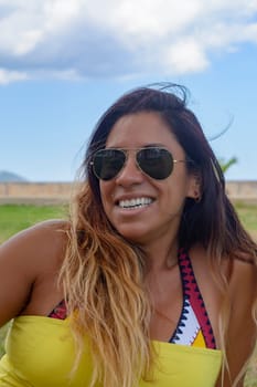 beautiful and happy latin woman with long hair smiling, having a good time, on vacation in mallorca hollidays concept,
