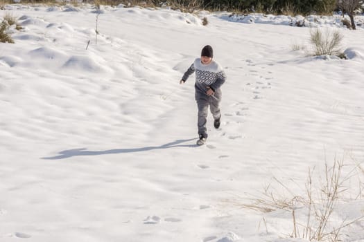 young man having fun running in big snow,